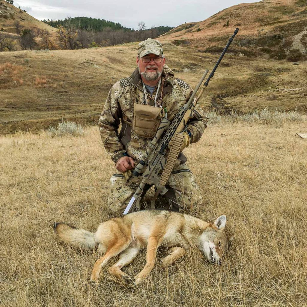 Jim Gades with one of his custom AR15's and a big North Dakota Coyote.